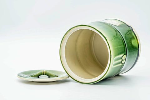 Jar tilted on its side with the lid removed, revealing the glazed interior.