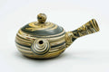 Front view of the marbled teapot with the spout to the left.