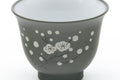 Tezumi — Japanese Teacup - Plum Blossom Ryokudei Tokoname White Inner-Glazed Yunomi - 60ml — tipped to show the interior