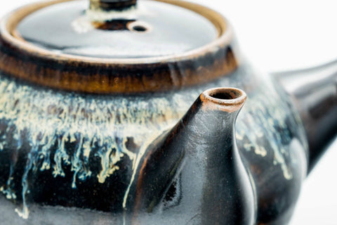 Close-up of the spout and the silvery drip-glaze streaks.