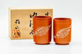 Pair of red shudei Tokoname-yaki yunomi teacups shown with their inscribed wooden box.