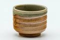 Tezumi — Japanese Teacup - Orange Green Spiraling Shigaraki-yaki Guinomi - 30ml — tipped to show the interior