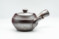 Banko-yaki kyusu teapot, front view, dark purple unglazed clay engraved with mountainous motifs, with side handle