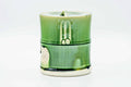 Green drip-glazed water jar (mizusashi) shaped like a bamboo segment, front view, with fitted lid.
