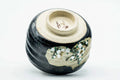 Inverted view of the black metallic chawan showing the foot and underside