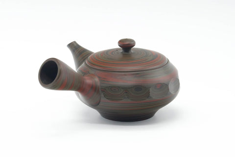 Side profile showing the spout, side handle, and faceted sides.
