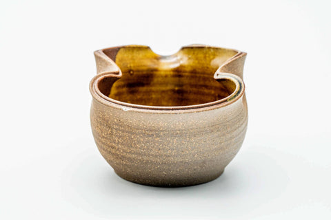Front view of the katakuchi revealing the amber pooled glaze inside.