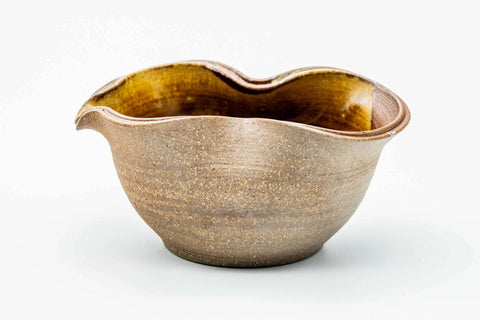 Side view of the ash-glazed katakuchi showing the pale banded exterior.