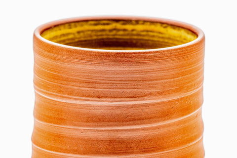 Close-up of a cup's interior, showing the yellow hakeme brushwork glaze.