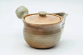 Beige weathered Hagi-yaki kyusu, front view with the spout facing forward