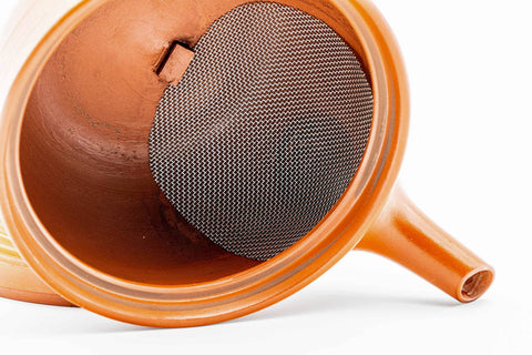The kyusu with the lid removed, showing the built-in mesh strainer; the lid rests beside it.
