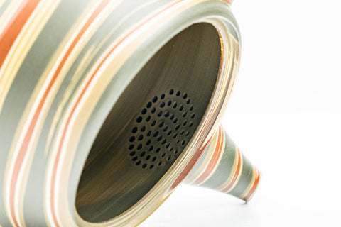 Japanese Kyusu - Green, Red, and Yellow Swirling Nerikomi Tokoname-yaki Do-ake Teapot - 240ml - closeup of the built-in ceramic mesh strainer