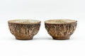 Pair of carved guinomi with green celadon interior glaze shown side by side