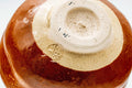Closeup of the foot and base of the aka-raku chawan with the maker's stamp