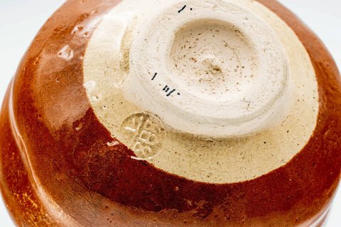 Closeup of the foot and base of the aka-raku chawan with the maker's stamp