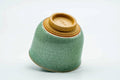 Teacup tilted to show the gold-painted foot.