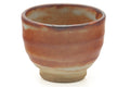 Tezumi — Japanese Teacup - Orange Shino Glazed Yunomi - 75ml — tipped to show the interior