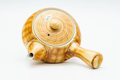 Overhead view of the teapot showing the domed lid and vertically ribbed body with side handle