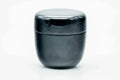 Glossy black-urushi matcha tea caddy, lid on, three-quarter view