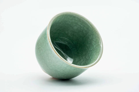 Teacup tilted to show the glazed interior and rim.