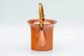Red shudei Tokoname dobin, front view with the gold top handle raised and spout to the left