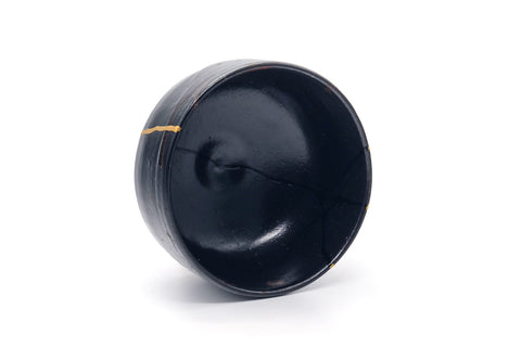 Overhead view into the glossy black interior of the bowl.