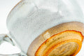 Cup tilted further to reveal the unglazed reddish-brown foot and base.