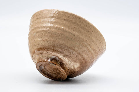 Biwa-iro Hagi chawan tilted to show the underside and trimmed foot ring (kodai)