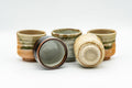Japanese Tea Set - Set of 5 Uniquely Glazed Shigaraki-yaki Guinomi - 50ml - the five teacups grouped, some tilted to show interiors and bases