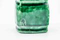 Closeup of the pooling green glaze on the futaoki's surface.