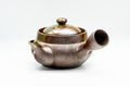 Front view with the lid seated, displaying the metallic ash-glaze surface.