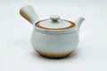 Rear three-quarter view of the white kyusu showing the side handle.