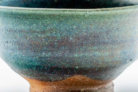 Close side view of the chawan emphasising the streaked turquoise-to-brown glaze.