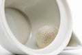 Close-up inside the white houhin showing the built-in mesh strainer.