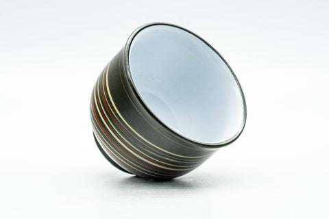 Inverted three-quarter view of the nerikomi yunomi showing the white-glazed interior and rim