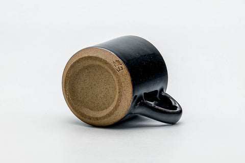 Tezumi — Japanese Teacup - Black Beige Drip-Glazed Ushirode Yunomi - 100ml — tipped to show the interior