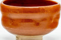 Side view of the aka-raku chawan showing the glossy red glaze