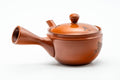 Angled view with the side handle at right and the spout to the lower left.