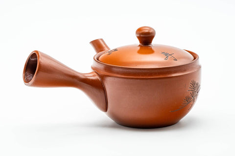Angled view with the side handle at right and the spout to the lower left.