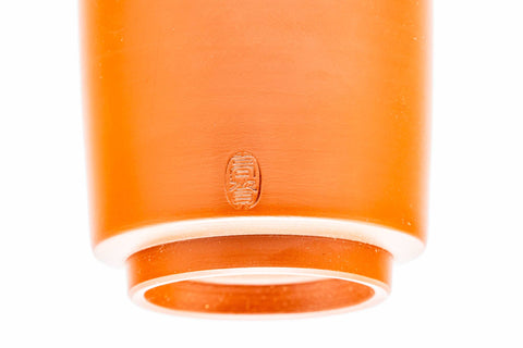 Underside close-up of a cup showing the foot and an impressed maker's mark.