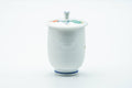 The lidded cup from the reverse, showing the plain side and blue rim line.