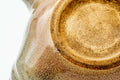 Closeup of the unglazed clay foot and glaze texture on the base of the beige Hagi-yaki kyusu