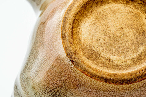 Closeup of the unglazed clay foot and glaze texture on the base of the beige Hagi-yaki kyusu