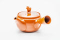 Red shudei Tokoname kyusu, side profile with the spout to the left