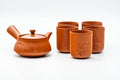 Red shudei Tokoname-yaki tea set: a side-handled kyusu teapot with five matching yunomi cups.
