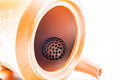 Close-up through the open teapot showing the fine ceramic mesh strainer inside.