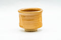 Beige amber-glazed Hagi-yaki guinomi, front view of the straight-sided cup with subtle throwing rings.