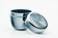 Small black lacquer natsume tea caddy opened, with the lid leaning against the base, three-quarter view.
