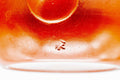 Closeup of the glossy red shudei body and base of the Tokoname kyusu with a small maker's stamp