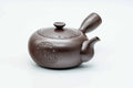 Purple-brown Banko-yaki side-handle kyusu, three-quarter view with lid on and engraved decoration